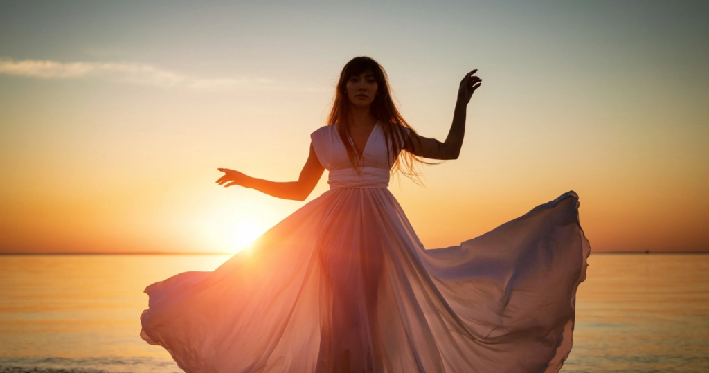 Kobieta w zwiewnej sukni o zachodzie słońca symbolizująca balans Yin i Yang