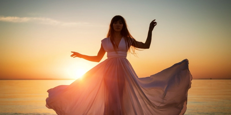 Kobieta w zwiewnej sukni o zachodzie słońca symbolizująca balans Yin i Yang